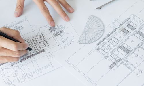 Architects engineer discussing at the table with blueprint - Closeup on hands and project print, Team group on construciton site check documents and business workflow.